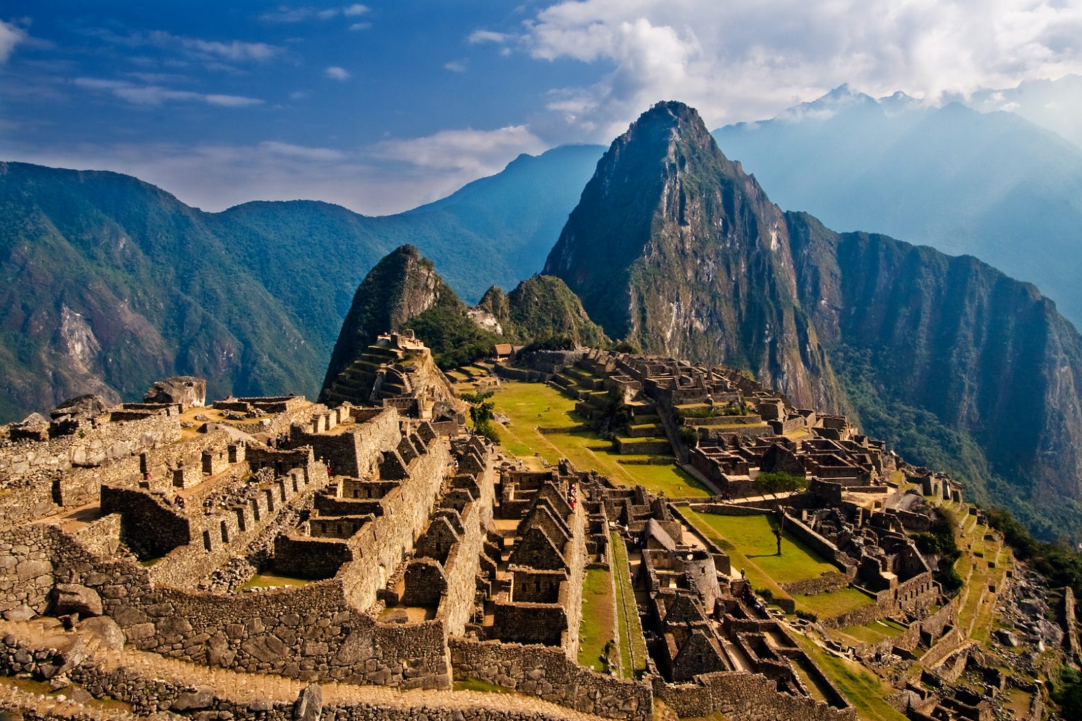 Ancient stone ruins high in the Andes mountains, covered in mist.